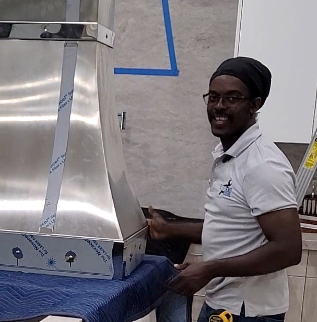 Gary Gayle working with a premium kitchen appliance during a residential installation